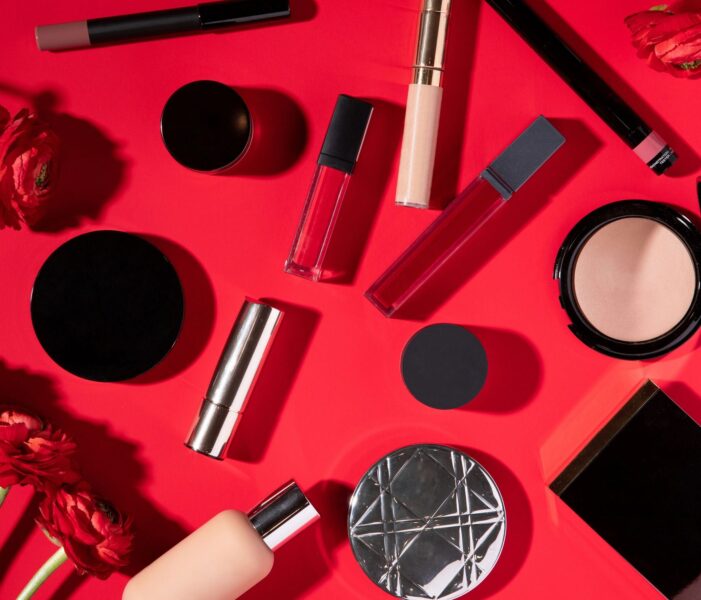 Cosmetics in beautiful style on red background. Top view, flat lay