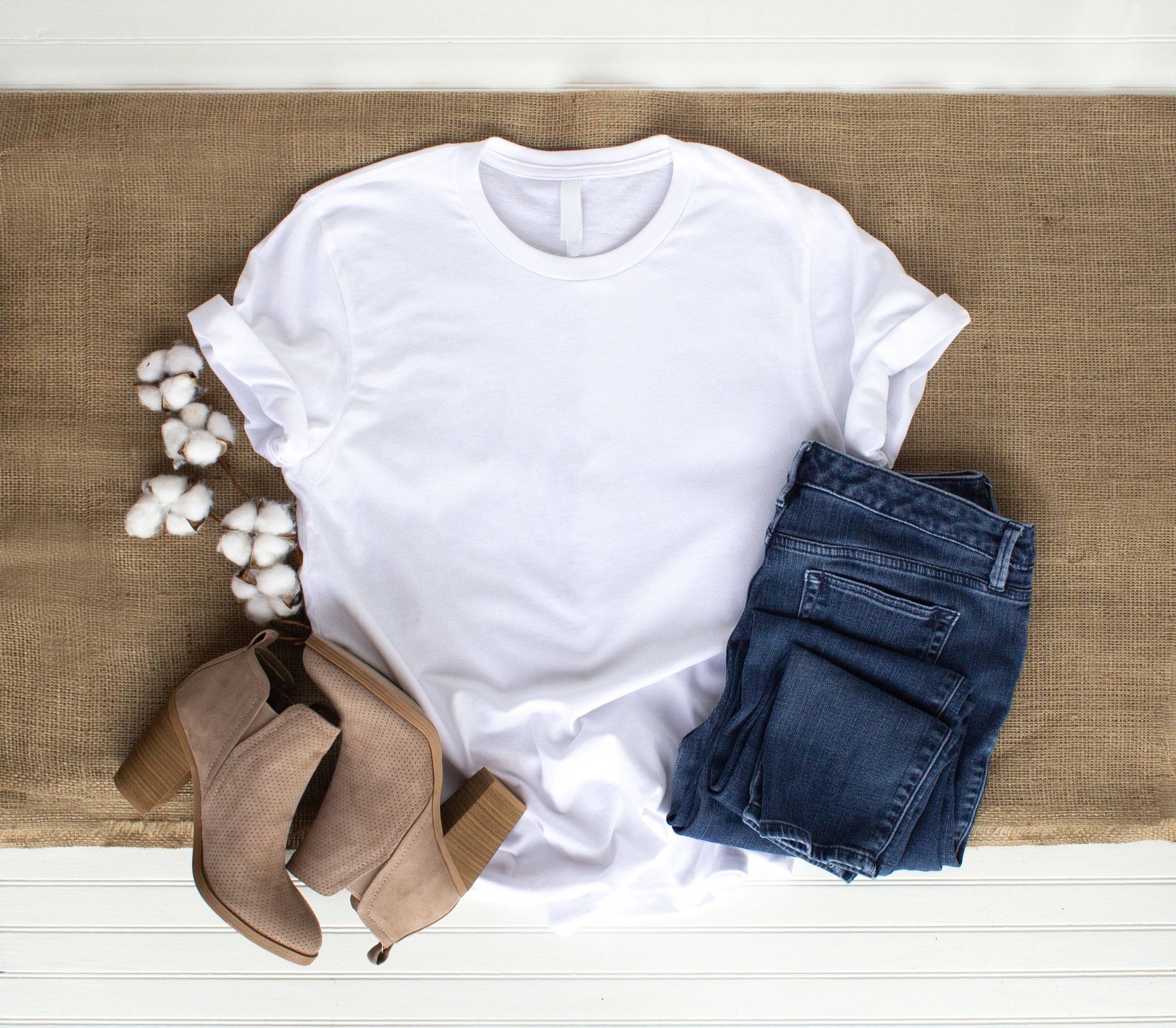 White t-shirt flat lay with casual accessories