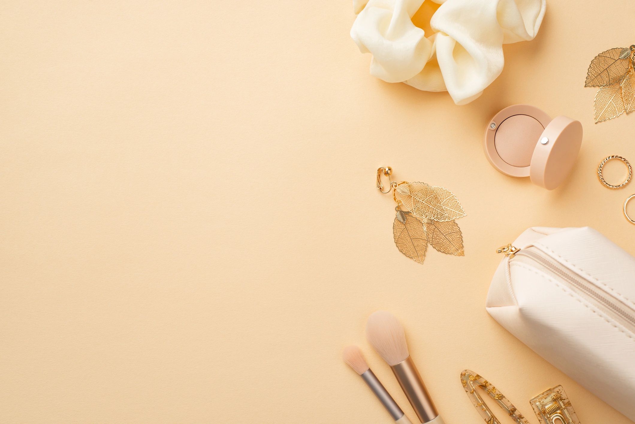 Beauty and jewelry flat lay on pastel yellow background