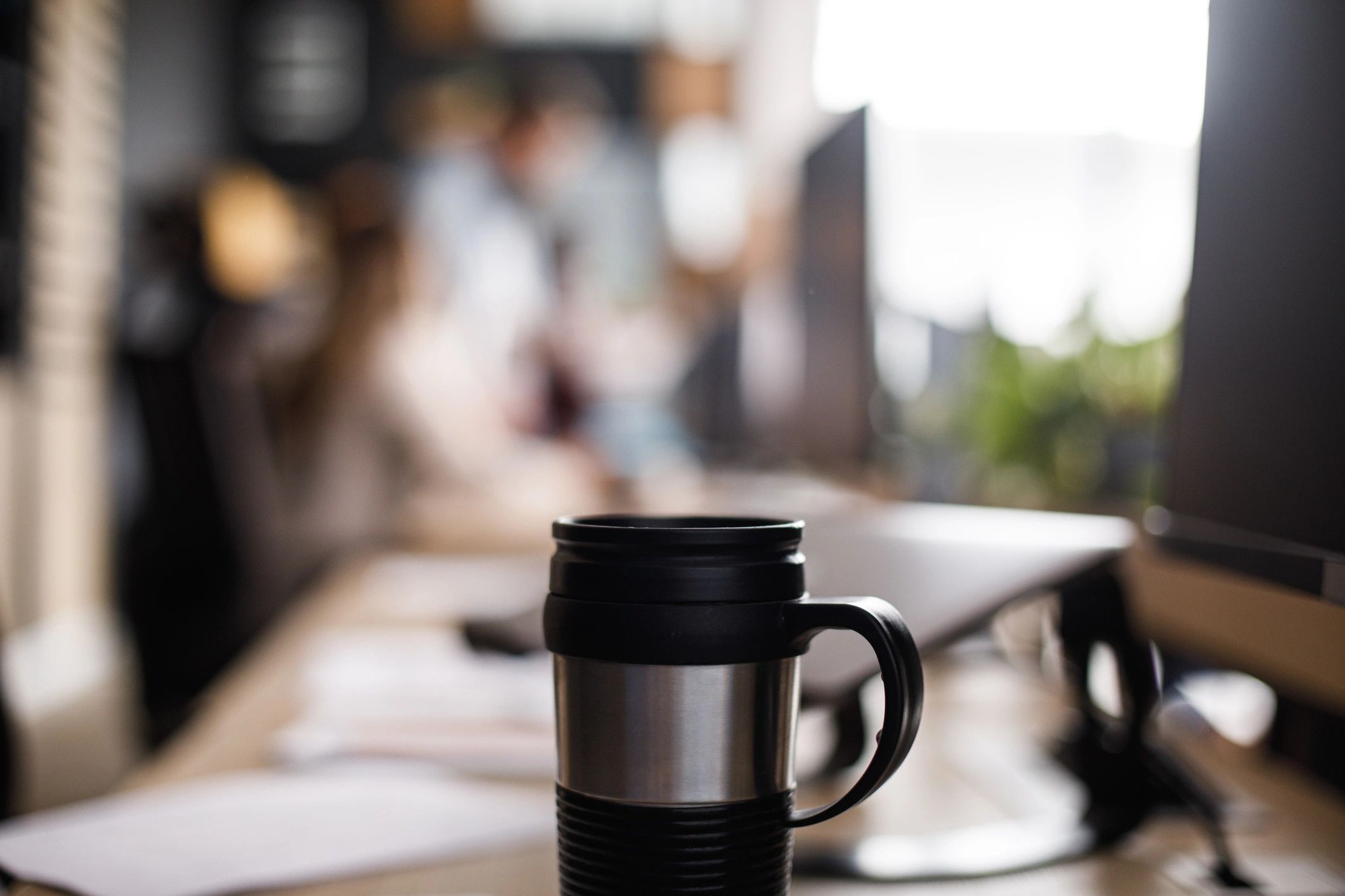 Reusable thermos with hot beverage on a desk