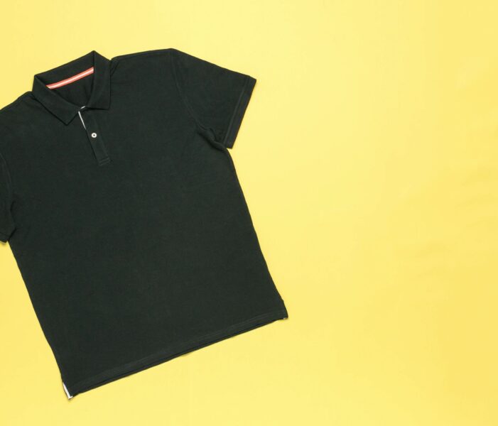 Classic men's polo shirt on a yellow background.