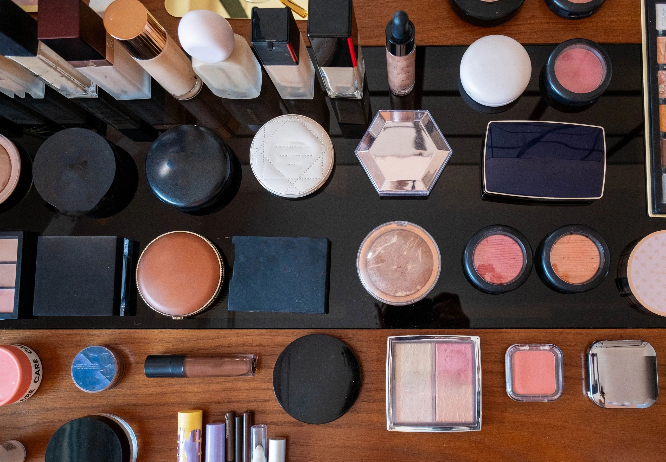 Assorted makeup products arranged on dark background