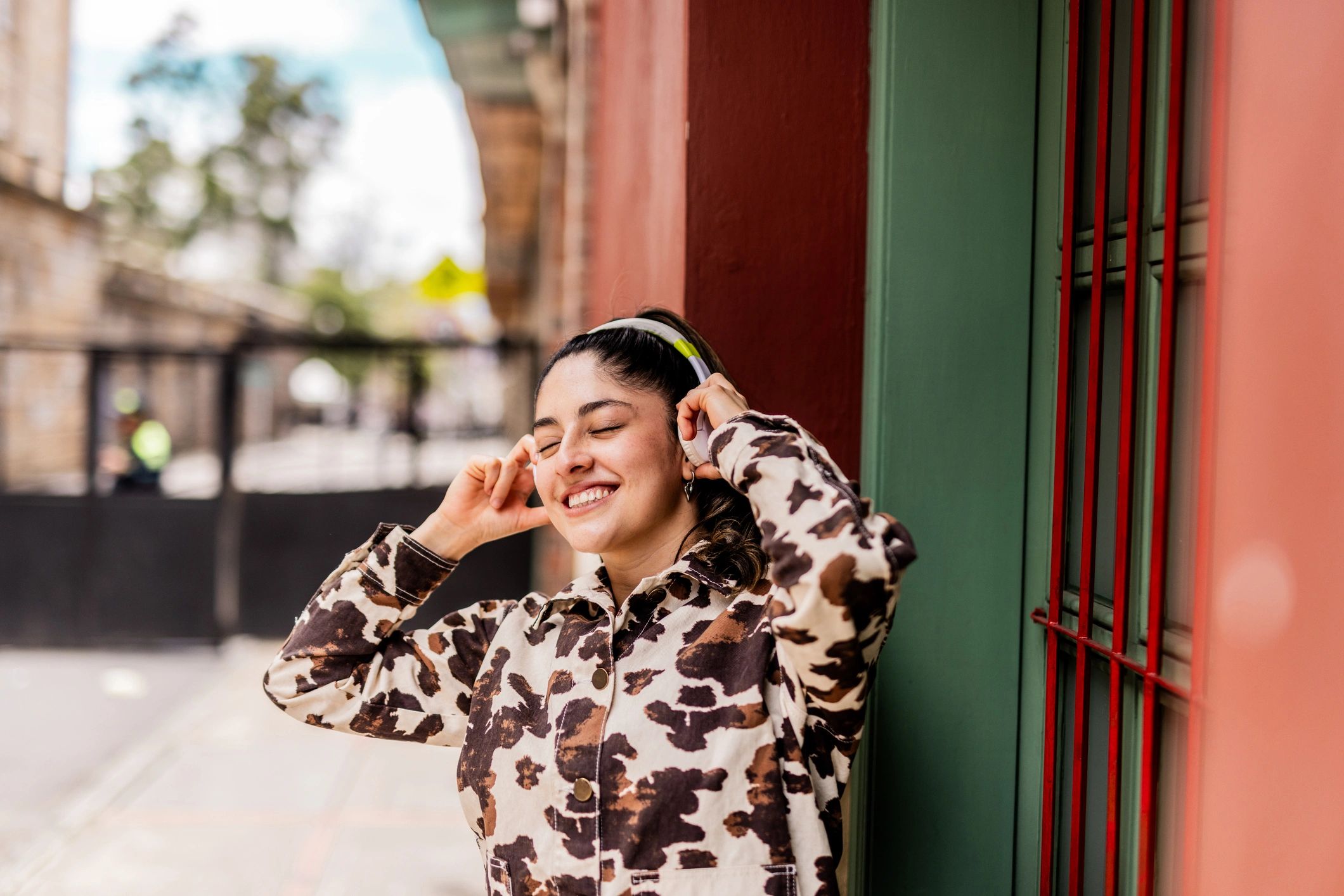 Young woman enjoying music outdoors with headphones