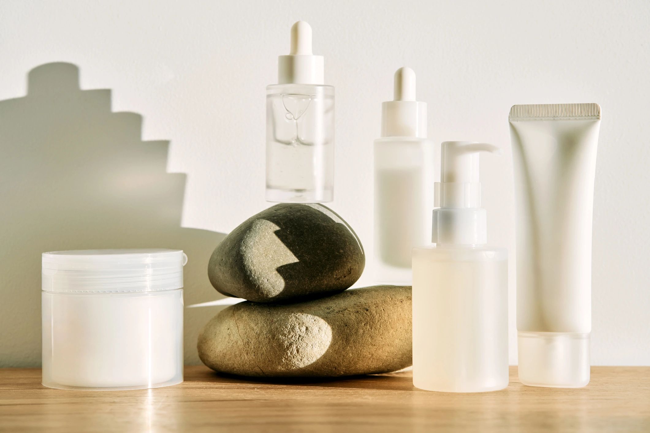 Minimal skincare products arranged with natural stones