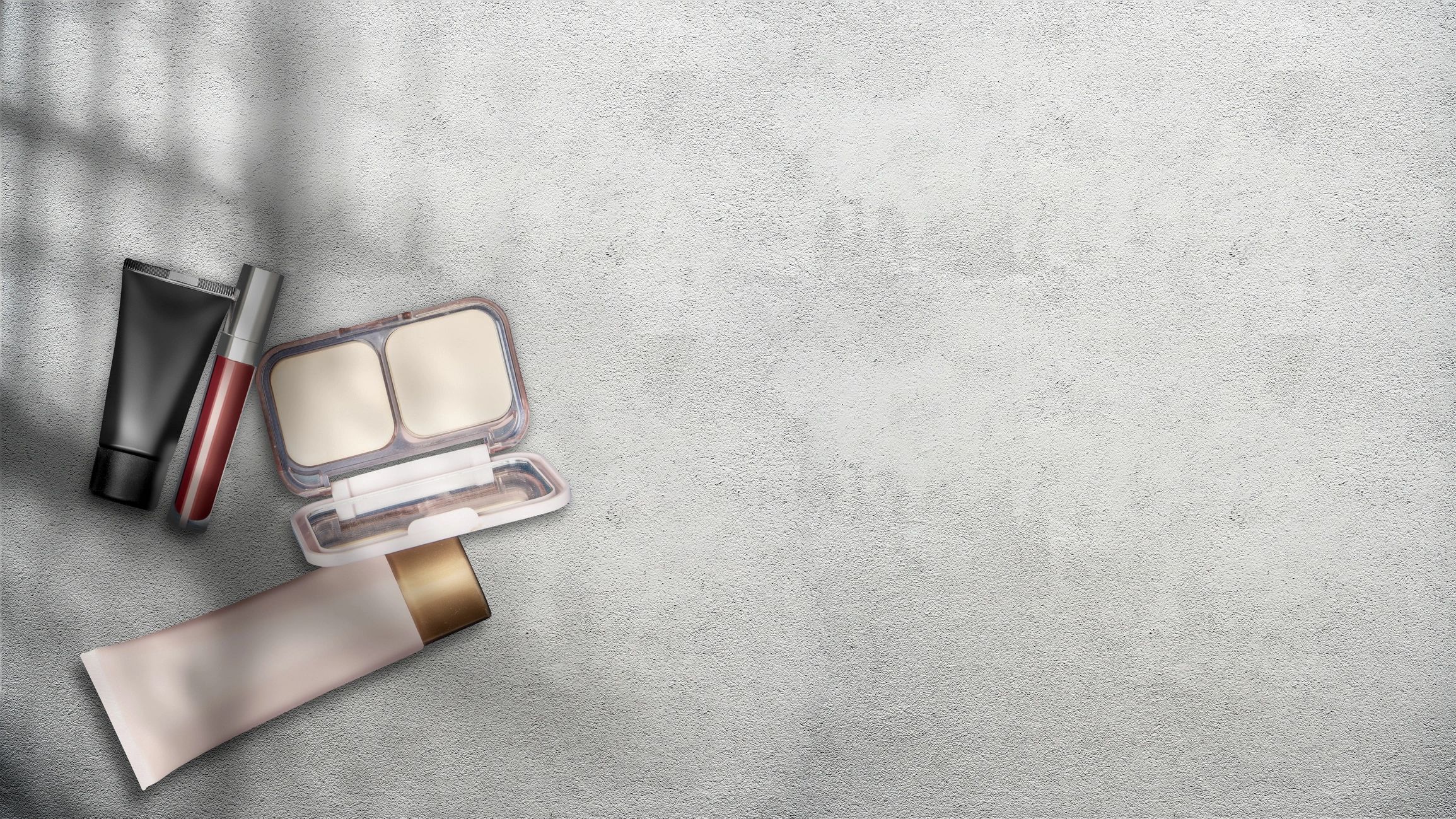 Beauty and skincare products on gray background with soft shadows