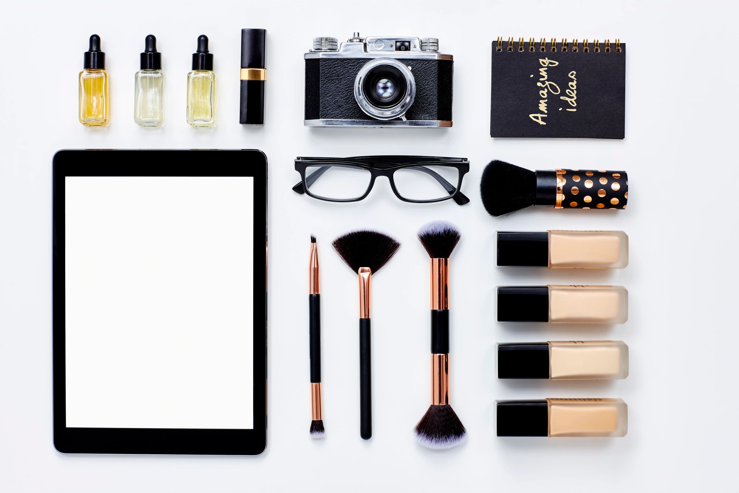 Flat lay of accessories and beauty products arranged neatly
